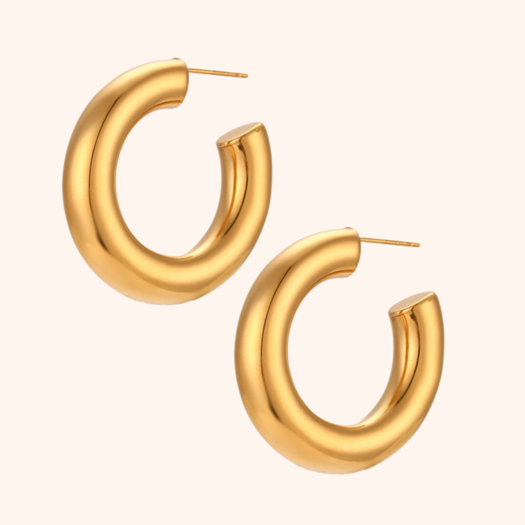 Chunky 18k gold hoop earrings with smooth polished finish and bold rounded shape